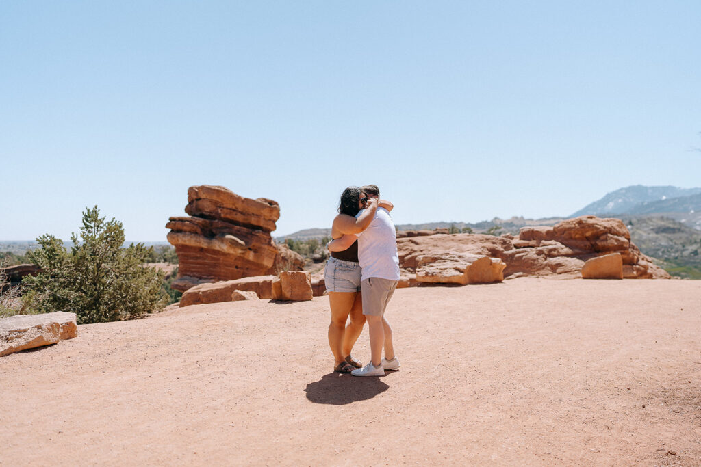 A couple hug after proposal at Garden of the Gods in Colorado Springs | Engagement photography