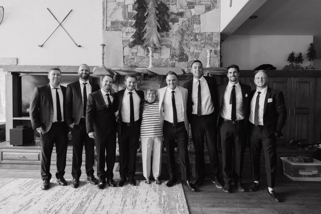 Group photo of the groom, family member, and groomsmen in black-and-white, celebrating a memorable Truckee wedding weekend.