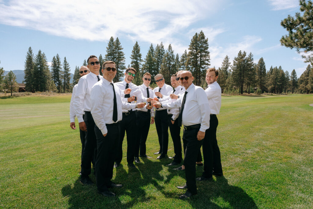 Groomsmen standing on a lush fairway with tall pines in the background, preparing for a Tahoe Mountain Club wedding in Truckee.