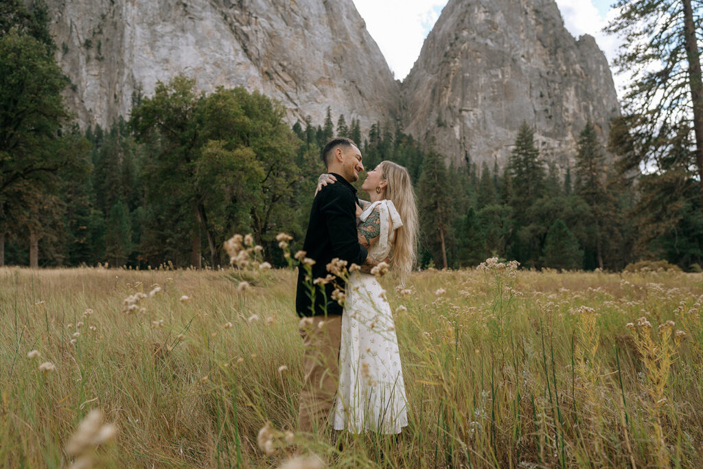 A couple sharing a quiet moment surrounded by tall grass in El Capitan Meadow, captured by a Yosemite photographer.