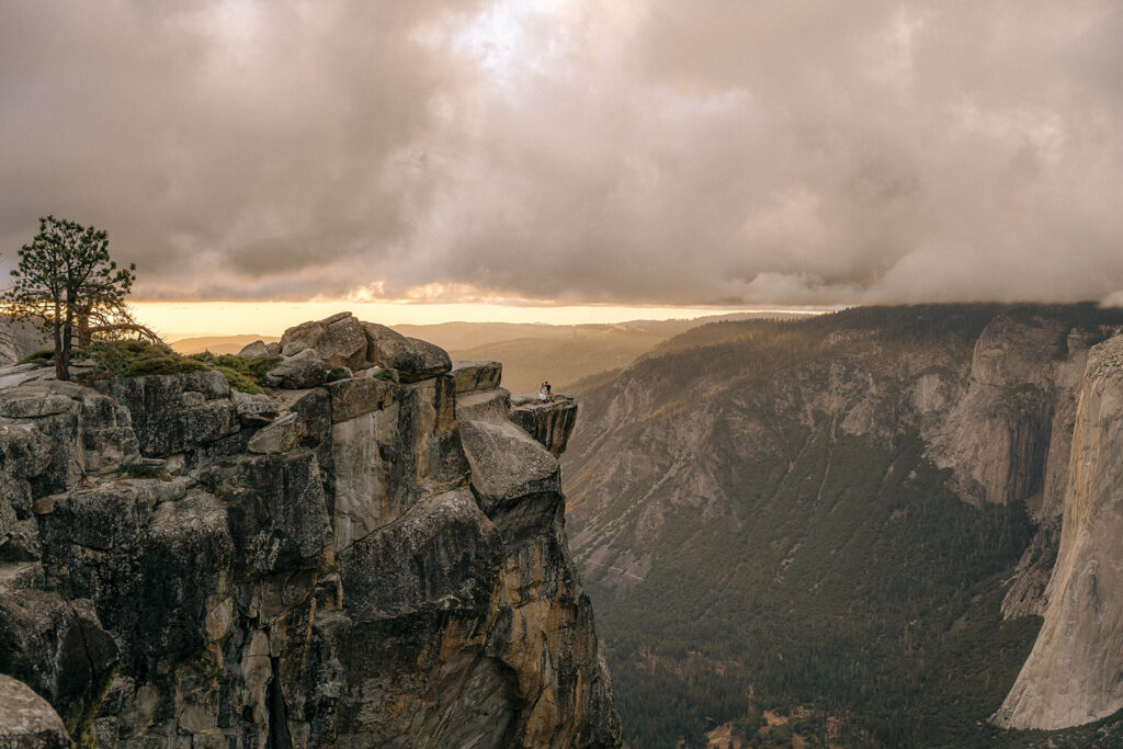 A dramatic view of the cliff edges at Taft Point as storm clouds roll through, captured by a Yosemite photographer.